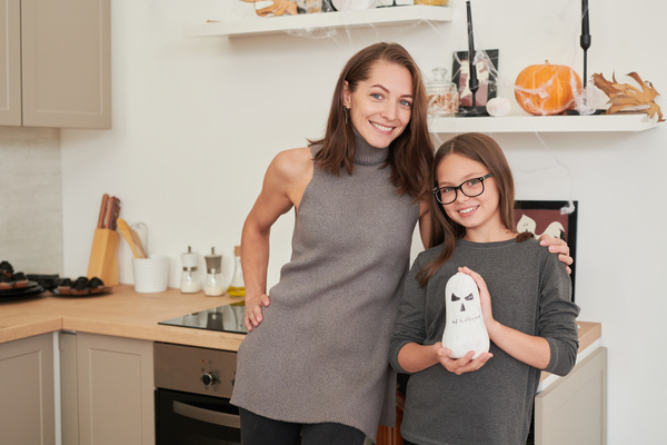 Girl with Her Mother Decorates Apartment for Halloween